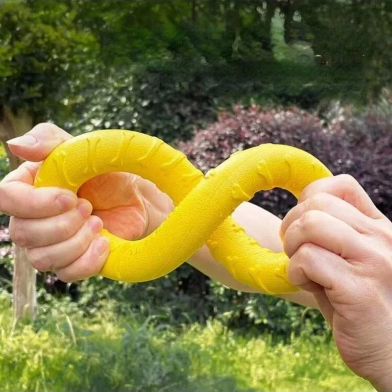 Border collie jumping to catch the yellow Durable Ring Chew & Fetch Toy outdoors in the grass